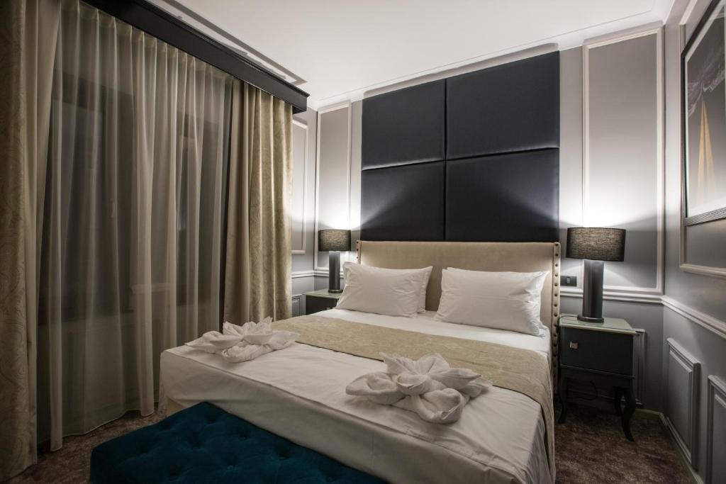 Postel nebo postele na pokoji v ubytování Peninsula Boutique Hotel