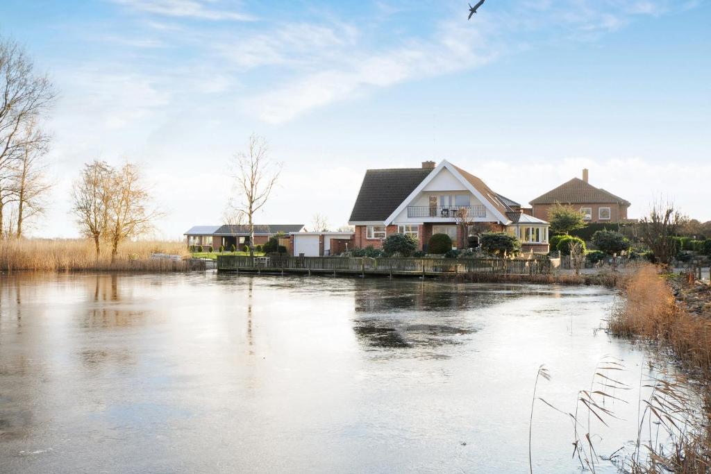 a house next to a river with houses at Bed and Breakfast Hasseloe in Nykøbing Falster