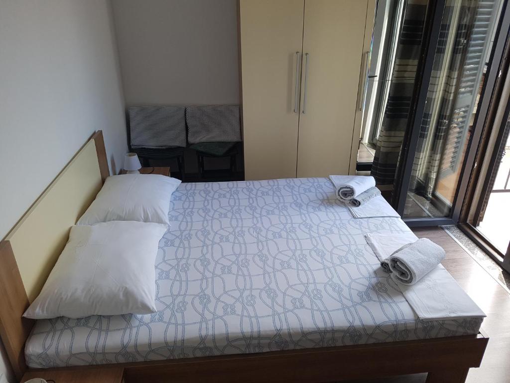 a bedroom with a bed with two pillows and a window at Guest House Sombrero in Senj