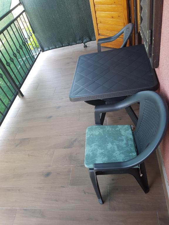 a table and a chair next to a table at Guest House Sombrero in Senj