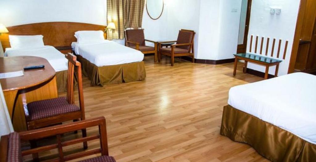 Postel nebo postele na pokoji v ubytování Ramee Guestline Tirupati