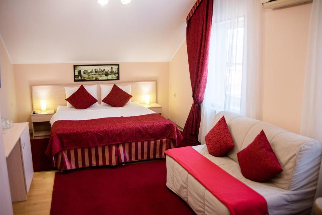 a hotel room with two beds with red pillows at Мини-отель Iris Inn in Krasnodar