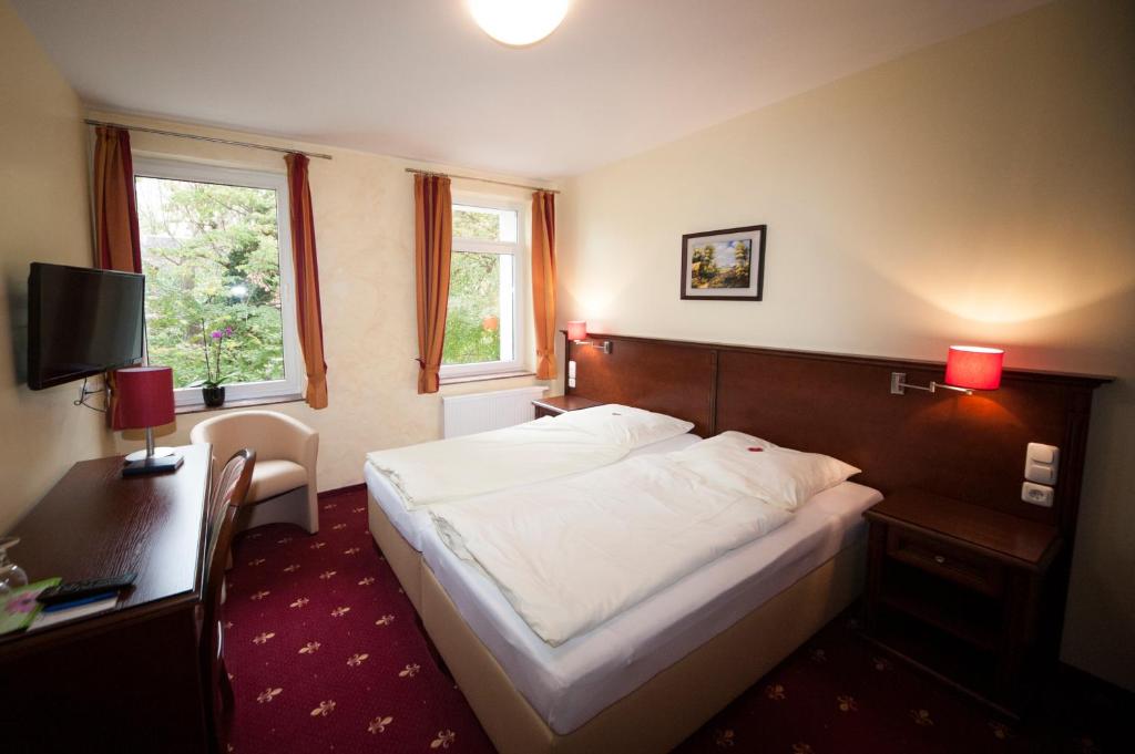 Postel nebo postele na pokoji v ubytování Hotel Medaillon
