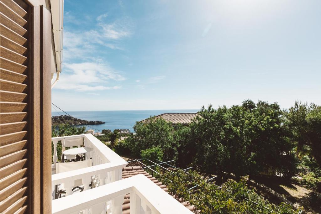a view of the ocean from the balcony of a house at Panorama Apartments updated with infinity pool in Agios Nikolaos