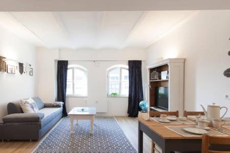 a living room with a couch and a table at Stadt-Apartment in Nuremberg