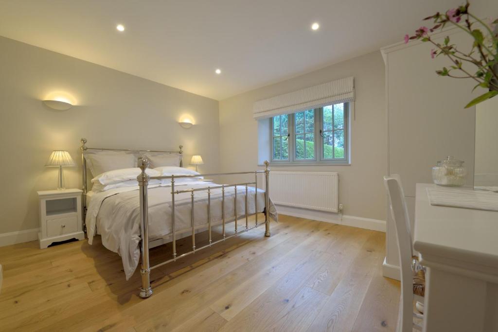a bedroom with a bed and a window at Pippin Heath House B&B in Holt