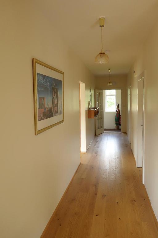 an empty hallway in a home with a wooden floor at Thorbrandsstadir Farm Holidays in Þorbrandsstaðir