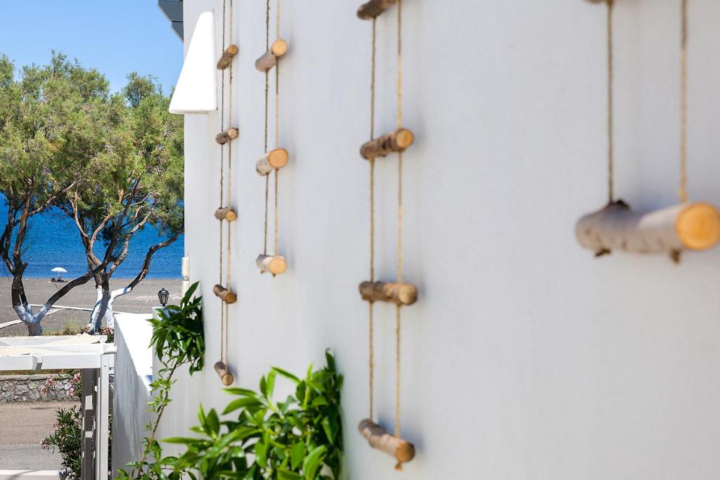 a wall with a bunch of wooden spheres on it at Memories Beach Hotel in Monolithos