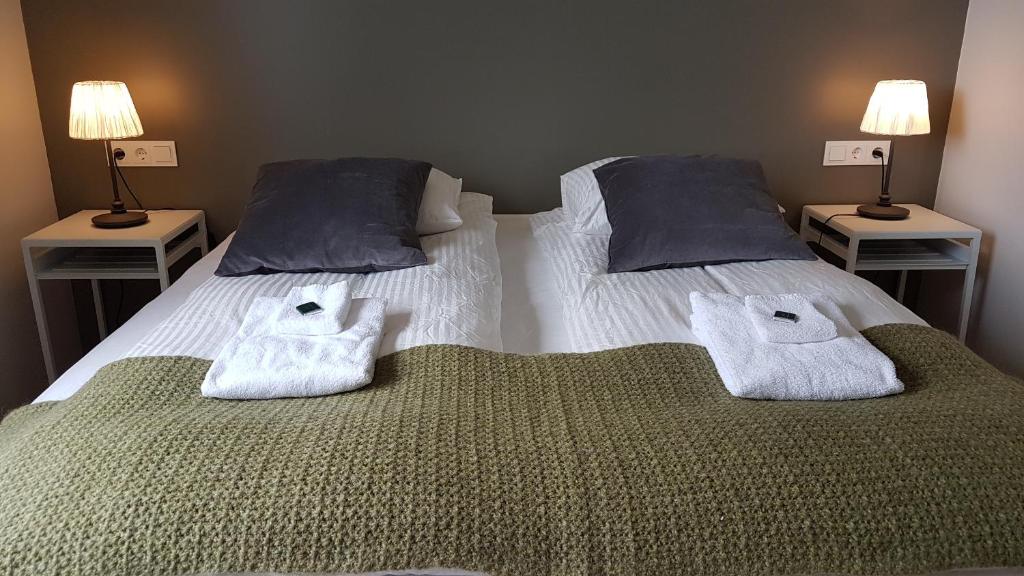 a bedroom with two beds with towels on them at Harbour Inn - Guesthouse in Bíldudalur