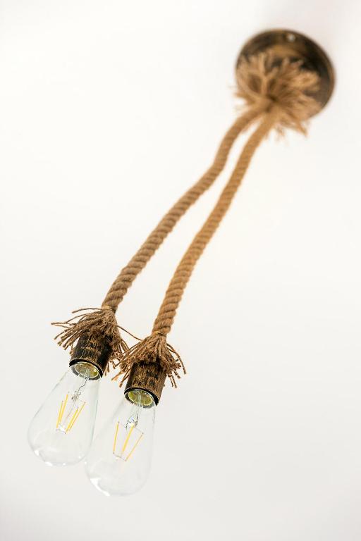 a chandelier with two lights and a rope at Memories Beach Hotel in Monolithos