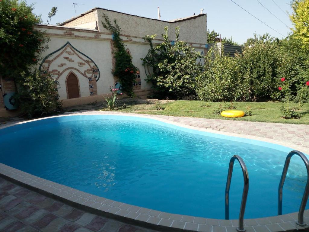 a swimming pool in the yard of a house at Hotel Latif Samarkand in Samarkand