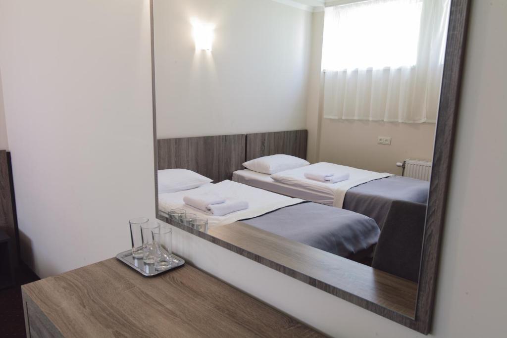 Postel nebo postele na pokoji v ubytování Zinedine Sport-Hotel