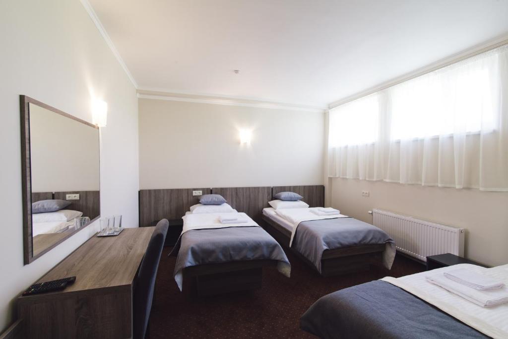 Postel nebo postele na pokoji v ubytování Zinedine Sport-Hotel