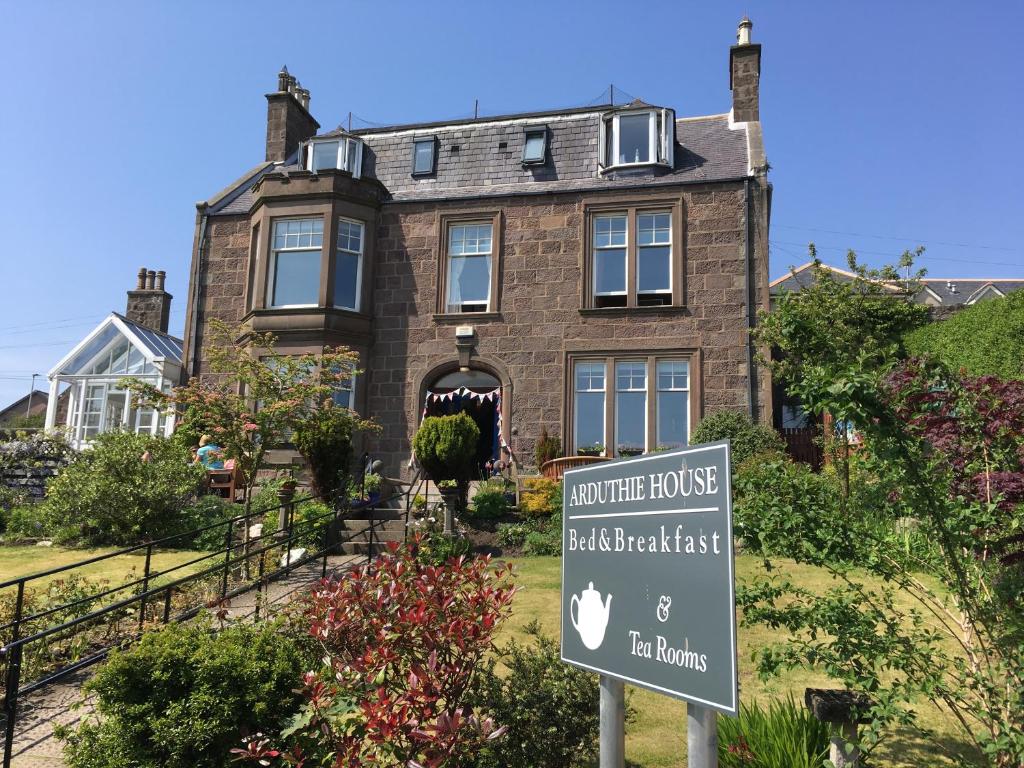 a house with a sign in front of it at Arduthie House in Stonehaven