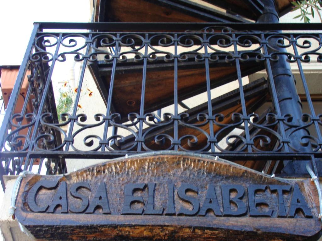a sign hanging from a wrought iron fence at Casa Elisabeta Constanta in Constanţa