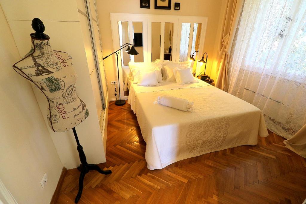 a bedroom with a bed and a dresser in a room at Apartment MiraMare on the beach in Split