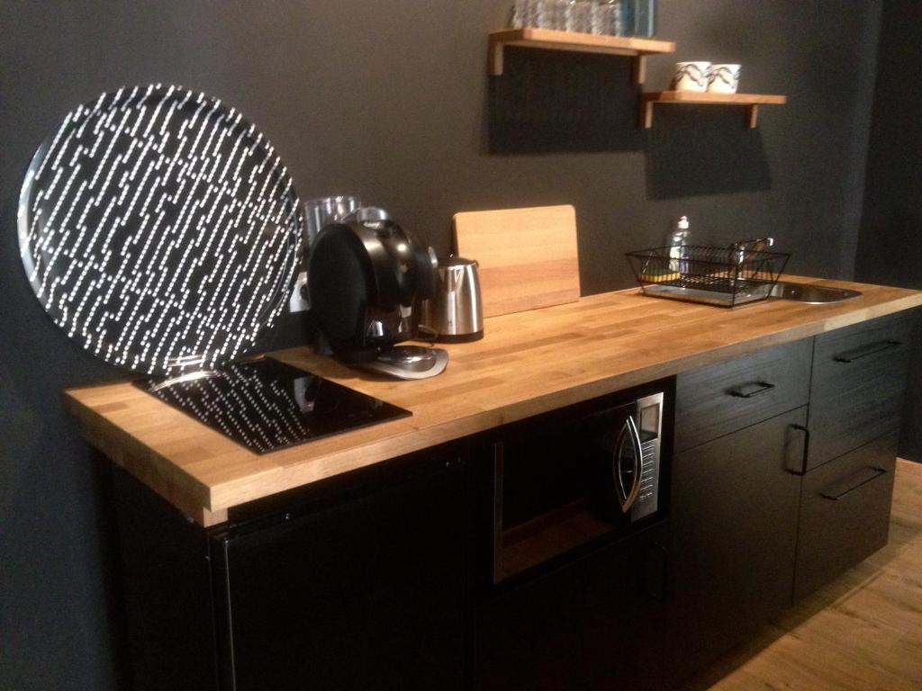 a kitchen with a wooden counter top with a mixer at Rose-INN appartement in Orange