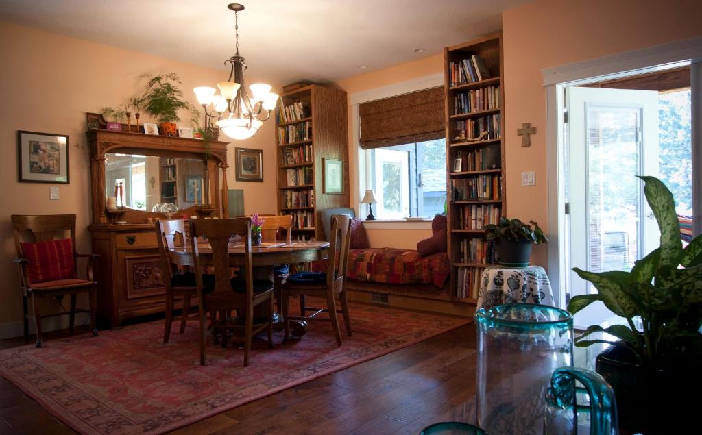 a dining room with a table and a living room with a couch at Salmon Point B&B in Oyster Bay