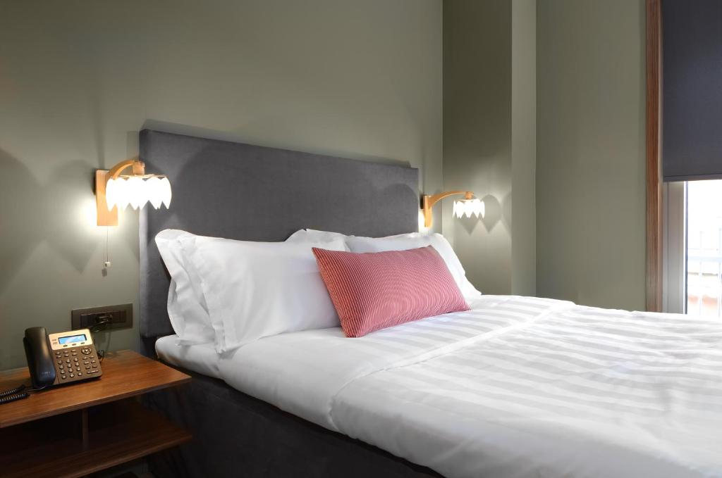 A bed or beds in a room at Lake Spirit Boutique Hotel & Spa