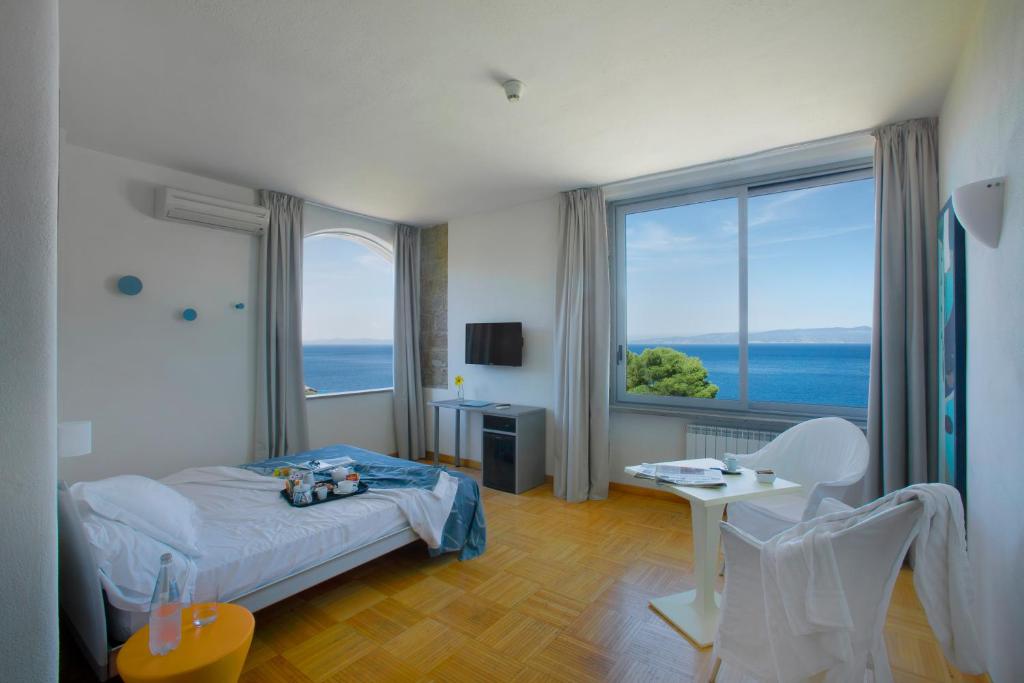 Postel nebo postele na pokoji v ubytování Hotel Arenella