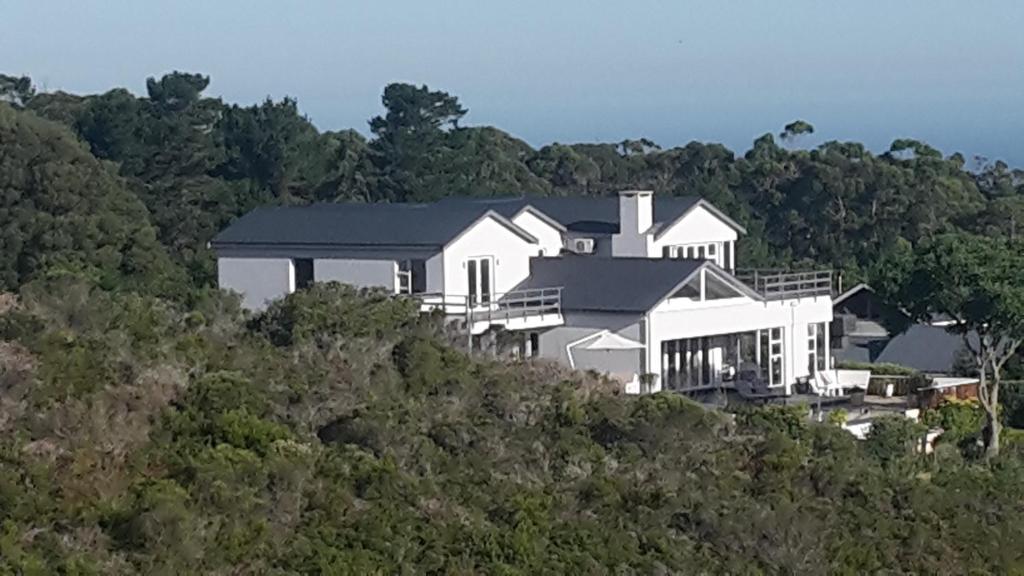 a large white house on top of a hill at Pezula Golf House in Knysna