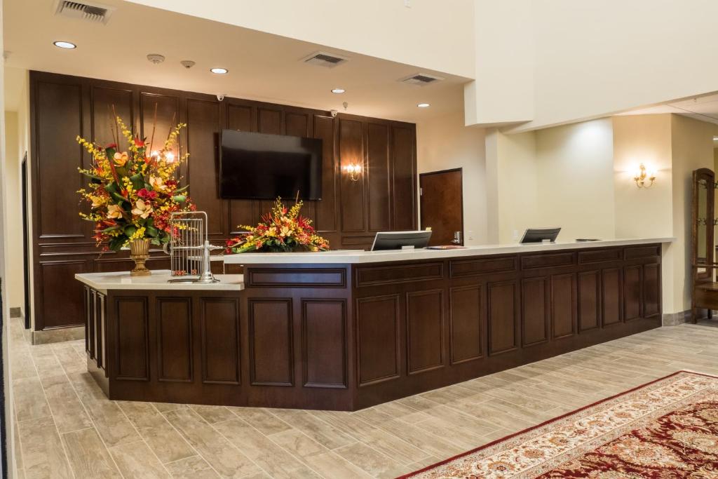 a lobby with a reception desk with flowers on it at Skyline Hotel and Casino in Las Vegas