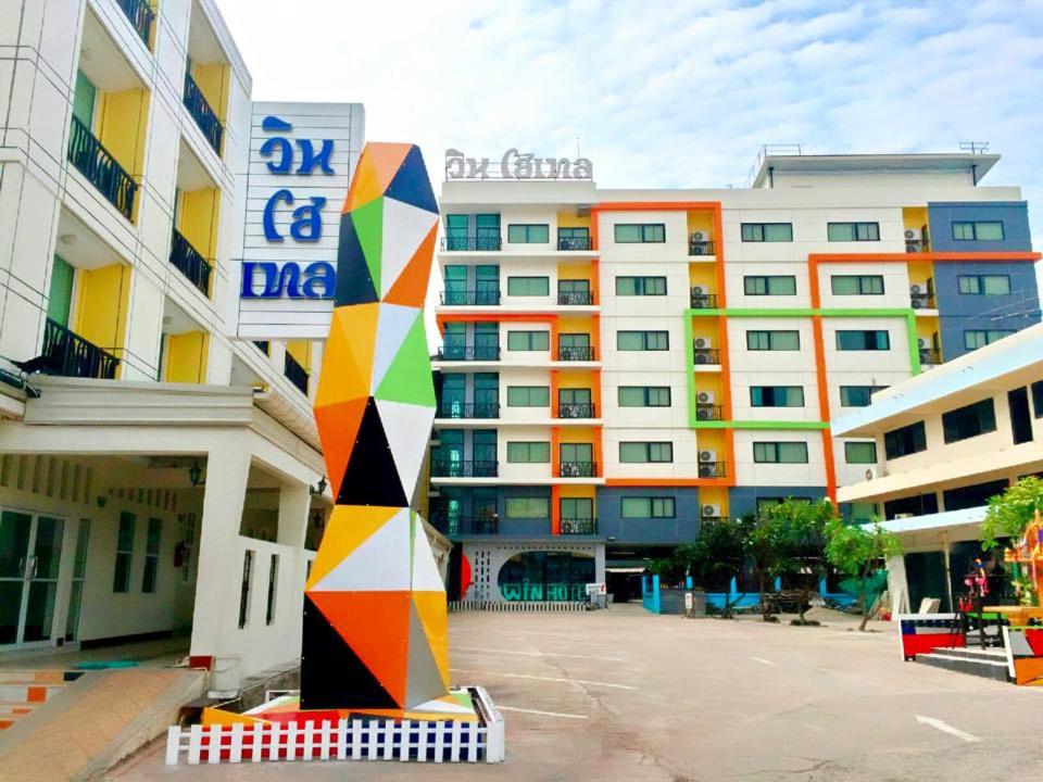 a large apartment building with a colorful building at Win Hotel Phayao in Phayao