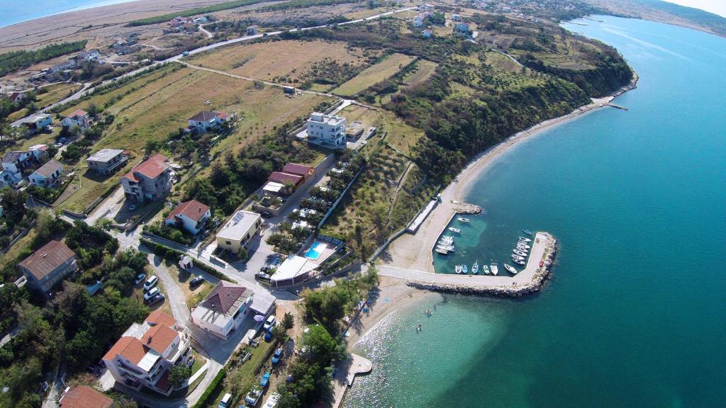 an aerial view of a house on an island in the water at Odmoree Camp & Hostel in Ražanac