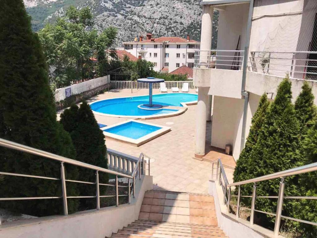 vistas a la piscina desde el balcón de una casa en Roman Garden Apartment en Risan