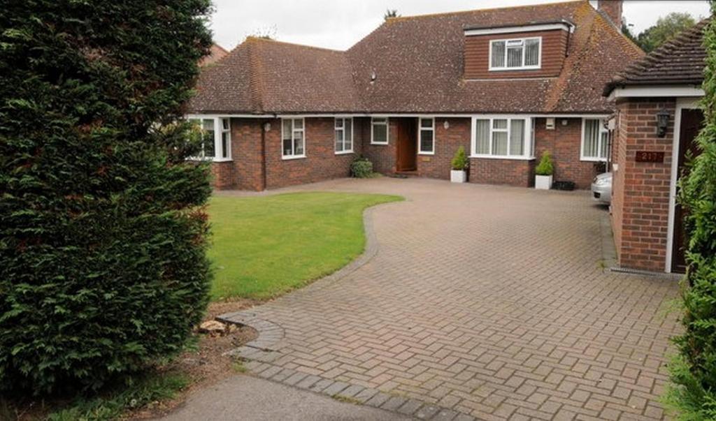 a brick house with a driveway in front of it at Hopewell self-catering in Gravesend