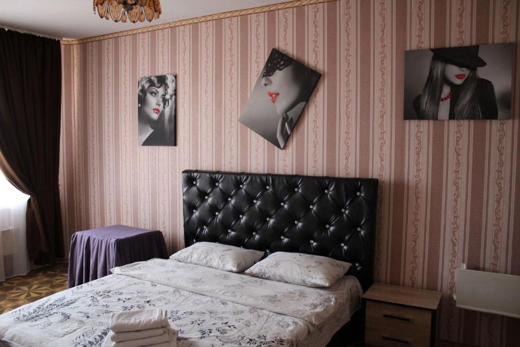a bedroom with a bed and pictures on the wall at Apartment on Fastivs'ka 2 in Bila Tserkva