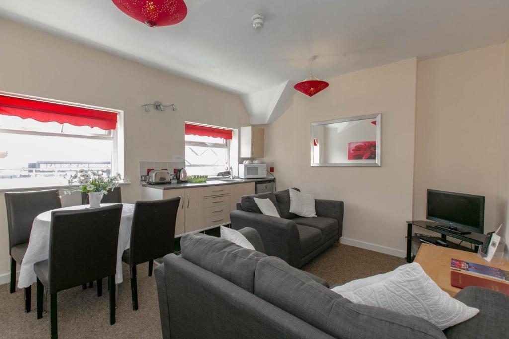 a living room with a couch and a table at Aparthotel Blackpool in Blackpool