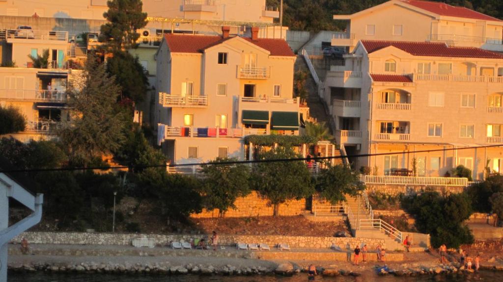 a group of buildings on the shore of a beach at Villa Obad Guest House in Neum