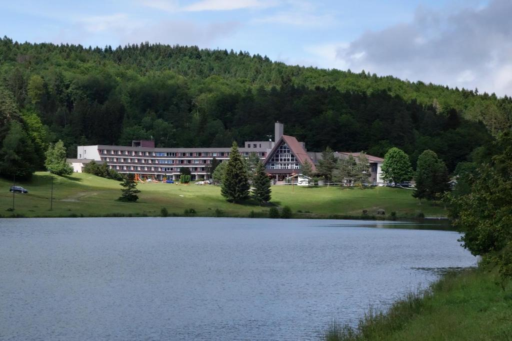 a large building next to a large body of water at Apartman 13 Vsemina in Všemina