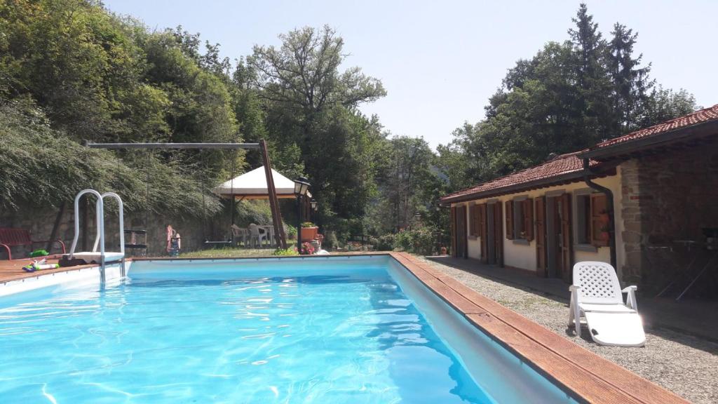 a swimming pool in front of a house at B&B Borgo Valagnesi in Pratovecchio