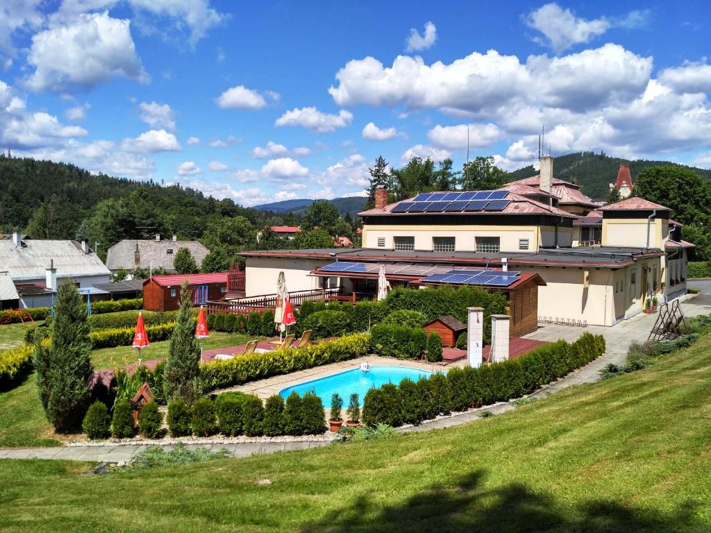 a house with a swimming pool in a yard at Pension Schaumannův Dvůr in Karlovice