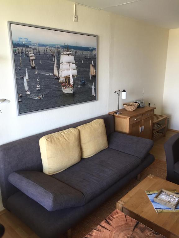 a living room with a couch and a painting on the wall at Ferienwohnung Marina Wendtorf in Wendtorf