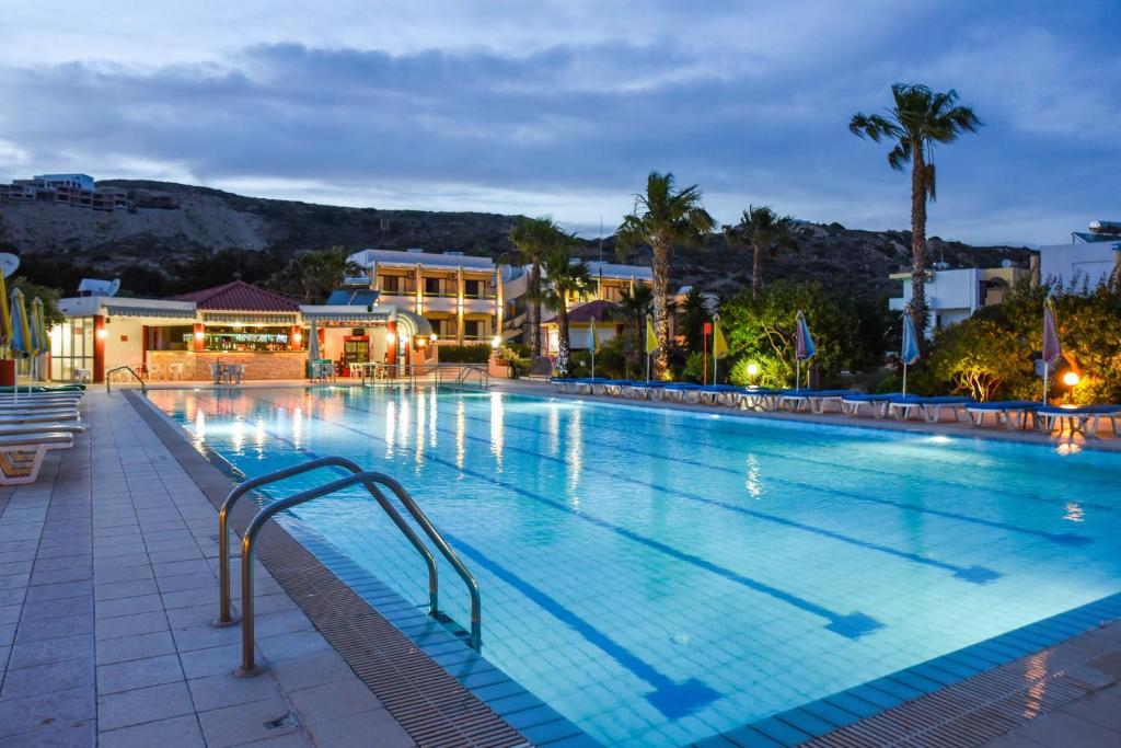 a large swimming pool at a resort at night at Chrysoula Hotel in Kefalos