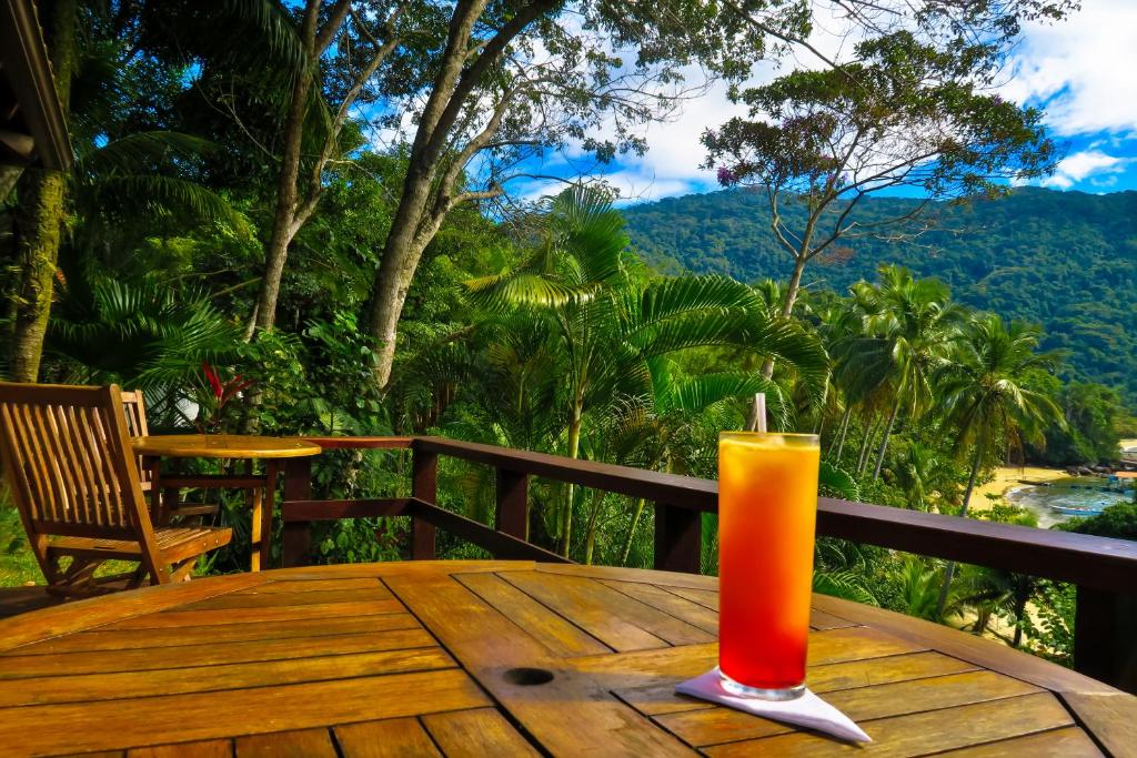 an orange candle sitting on a wooden table at Atlantica Jungle Lodge in Abraão