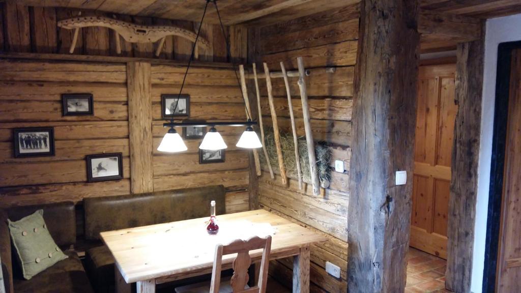 a wooden dining room with a wooden table and lights at Haus Mehrl in Mauterndorf