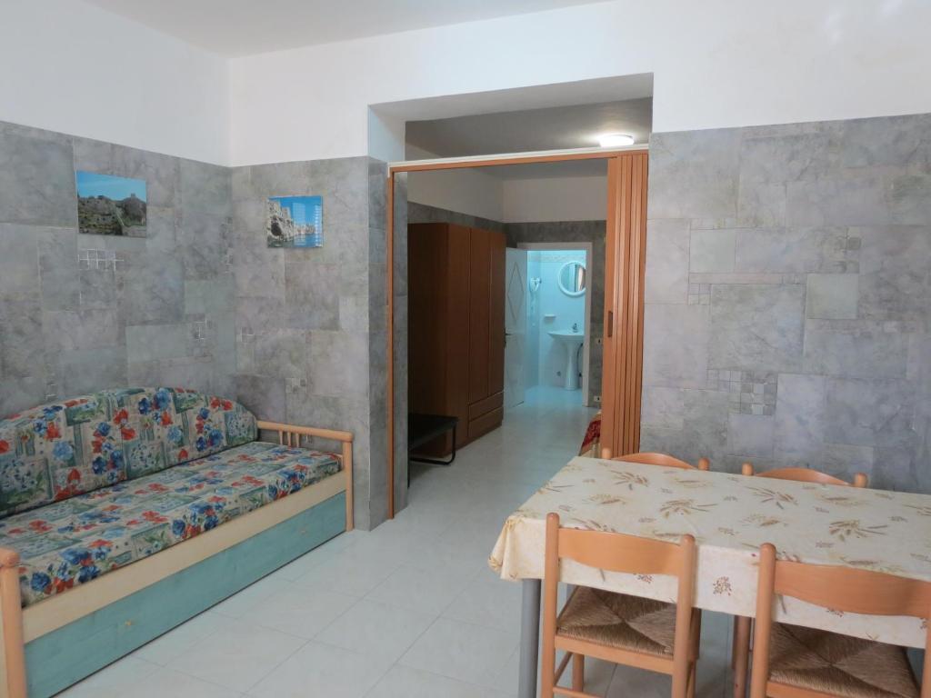 a living room with a couch and a table and a room at Hotel Residence Villa Ascoli in Vieste