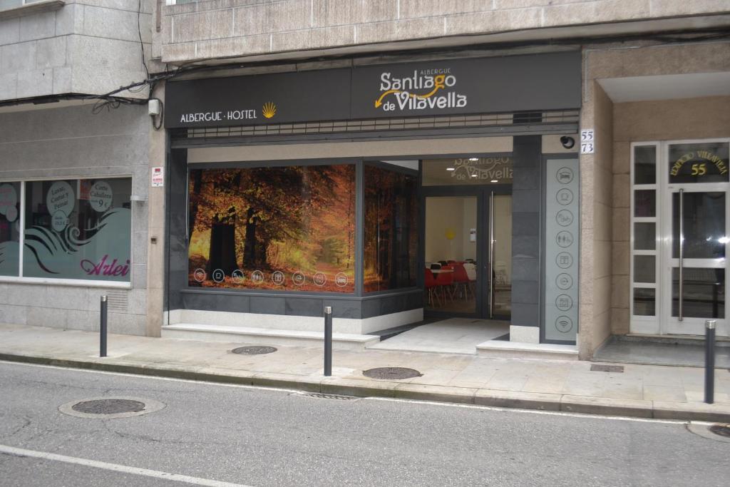a store front with a sign on the side of the building at Santiago de Vilavella in Redondela