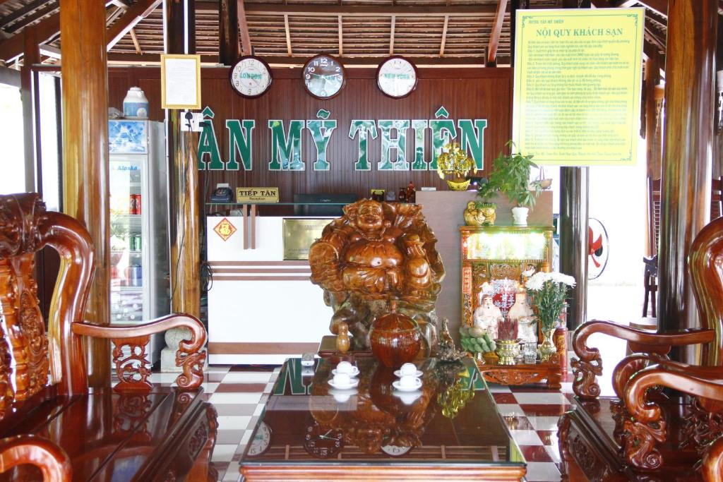 a store window with a counter with clocks on the wall at Tan My Thien Hotel in Tây Ninh