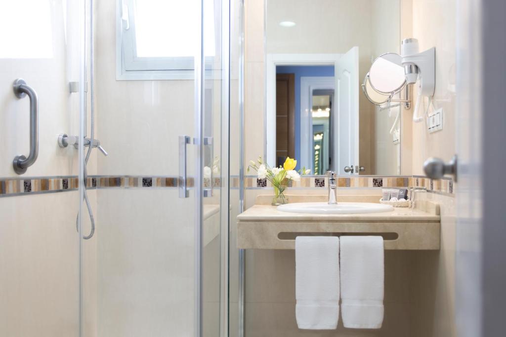 a bathroom with a sink and a shower at Hotel Plaza Cavana in Nerja