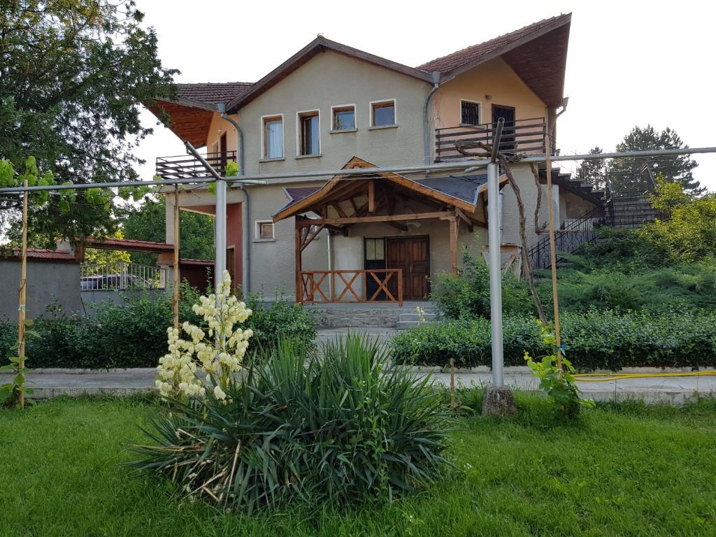 une maison avec une terrasse couverte et une cour dans l'établissement Guest House Sadovo, à Sadovo