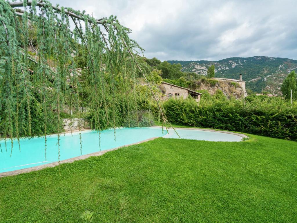 a swimming pool in the yard of a house at Belvilla by OYO Cobert de l Era in Oden