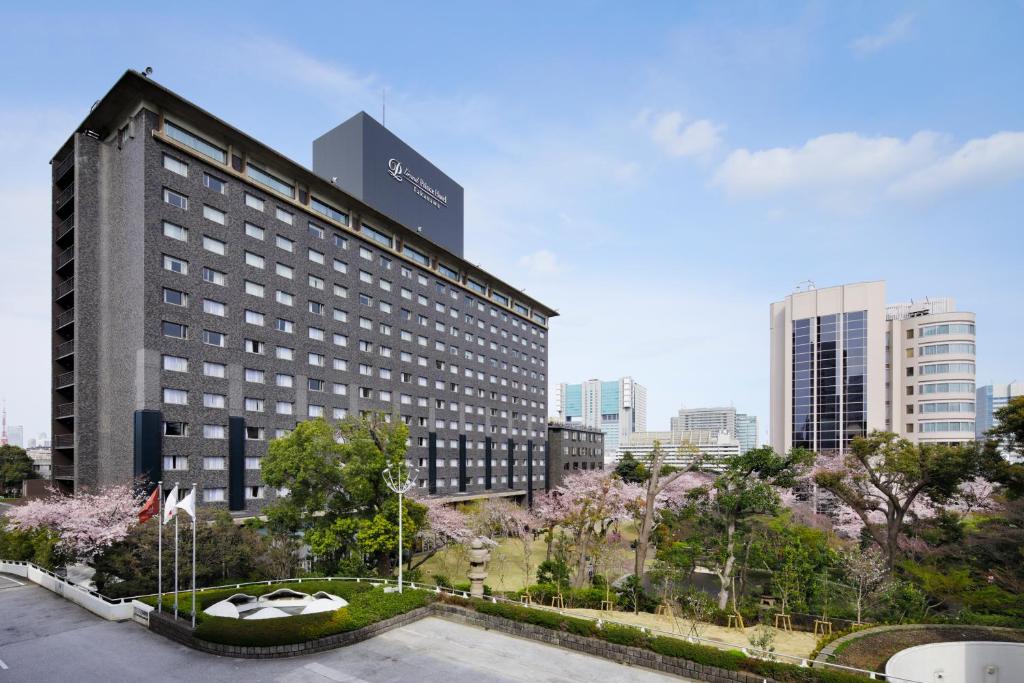a tall building with a sign on it in a city at Grand Prince Hotel Takanawa in Tokyo