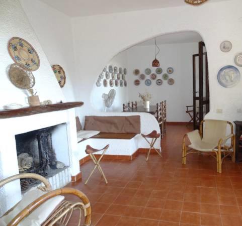 a living room with a bed and a fireplace at Villa Liliana P9275 in Torre delle Stelle
