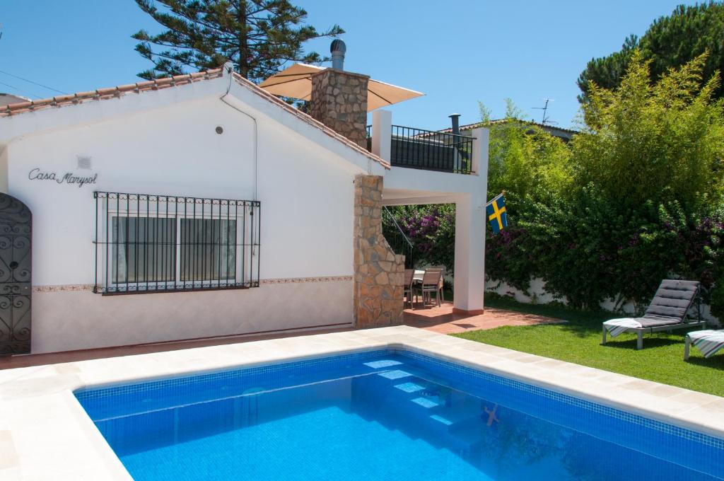 a villa with a swimming pool and a house at Villa Marysol sleeps 6 in Fuengirola