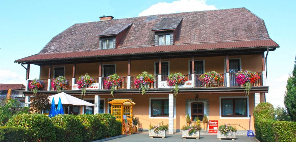 a large house with flower boxes on the balconies at Gasthof Herlwirt in Ligist